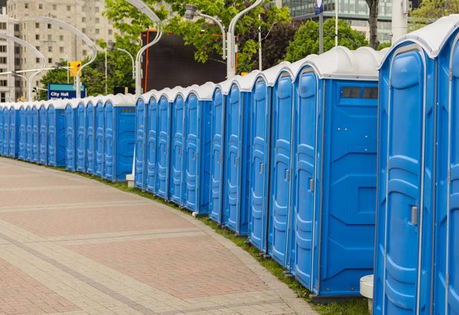 a row of portable restrooms set up for a large athletic event, allowing participants and spectators to easily take care of their needs in Southport CT